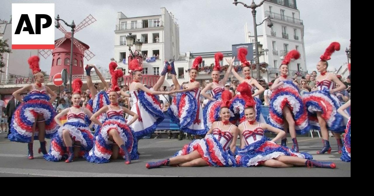 Moulin Rouge dancers perform for cyclists in the Olympics road race