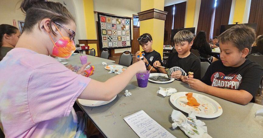 COLORFUL DINOS: Summer school kids spend afternoon painting dinosaurs