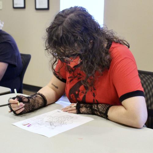 Mars Childress works on a coloring page
