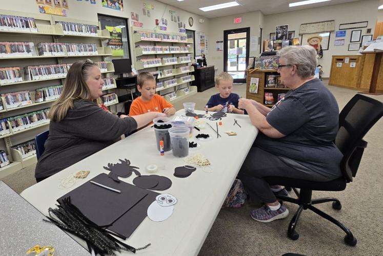 CLIMBING SPIDERS Hulbert library has children practicing art