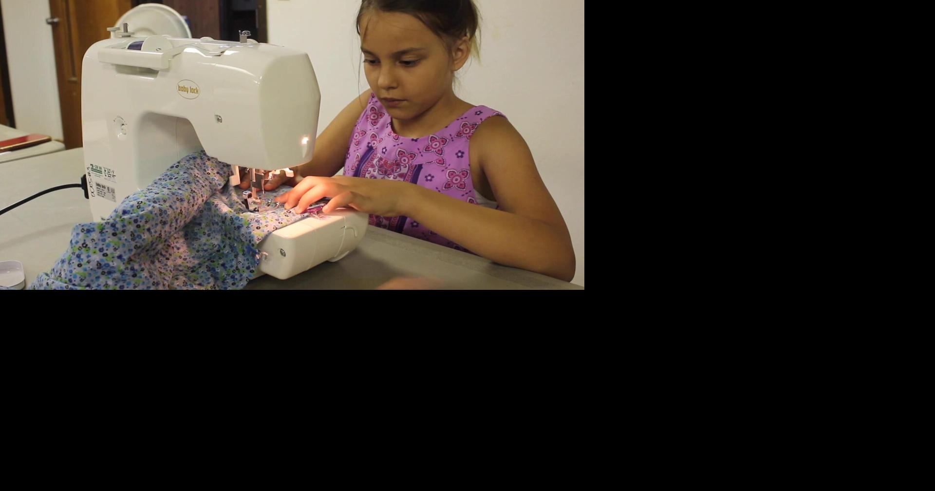Camper Vidia McMurray works on her sewing project