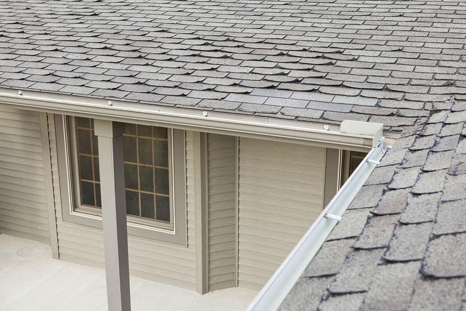 What causes curled roof shingles?