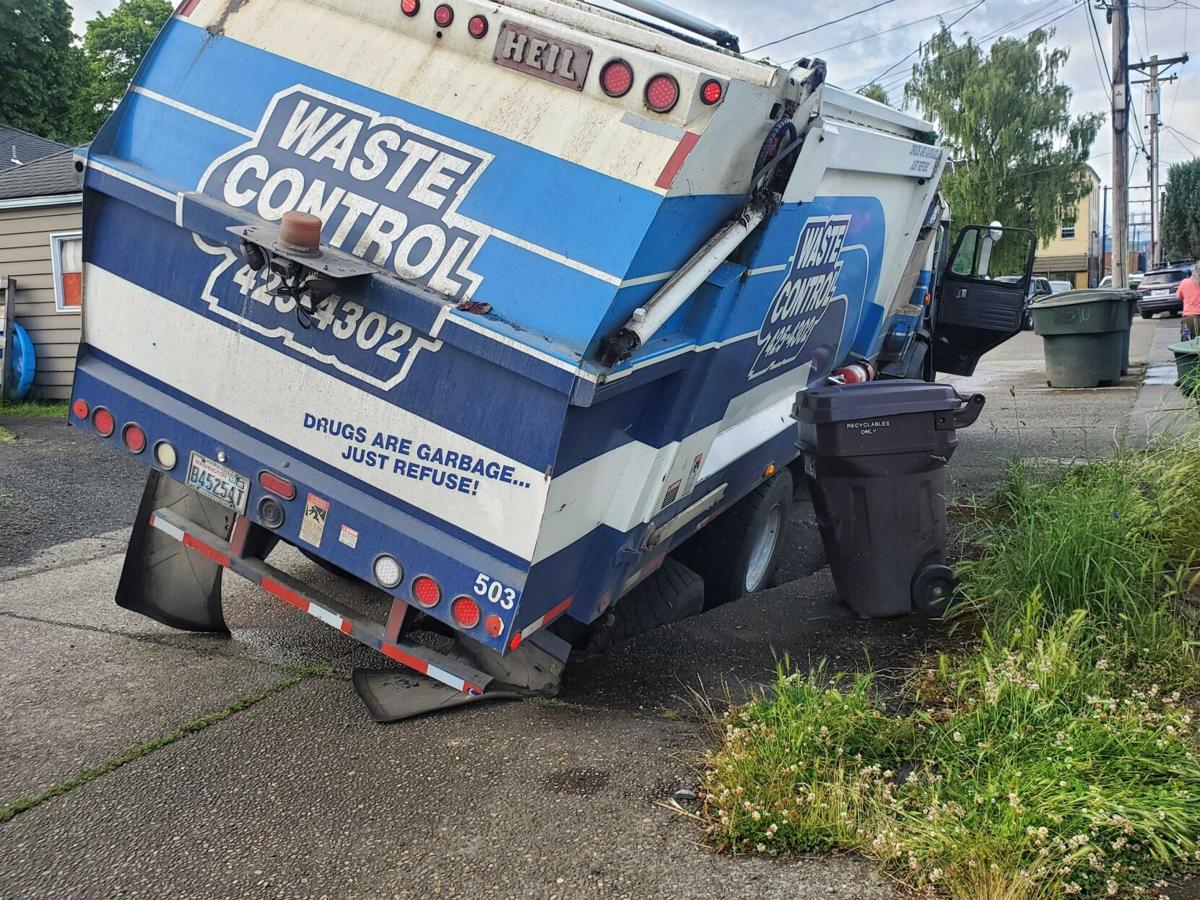 Waste Control truck falls in Longview sinkhole