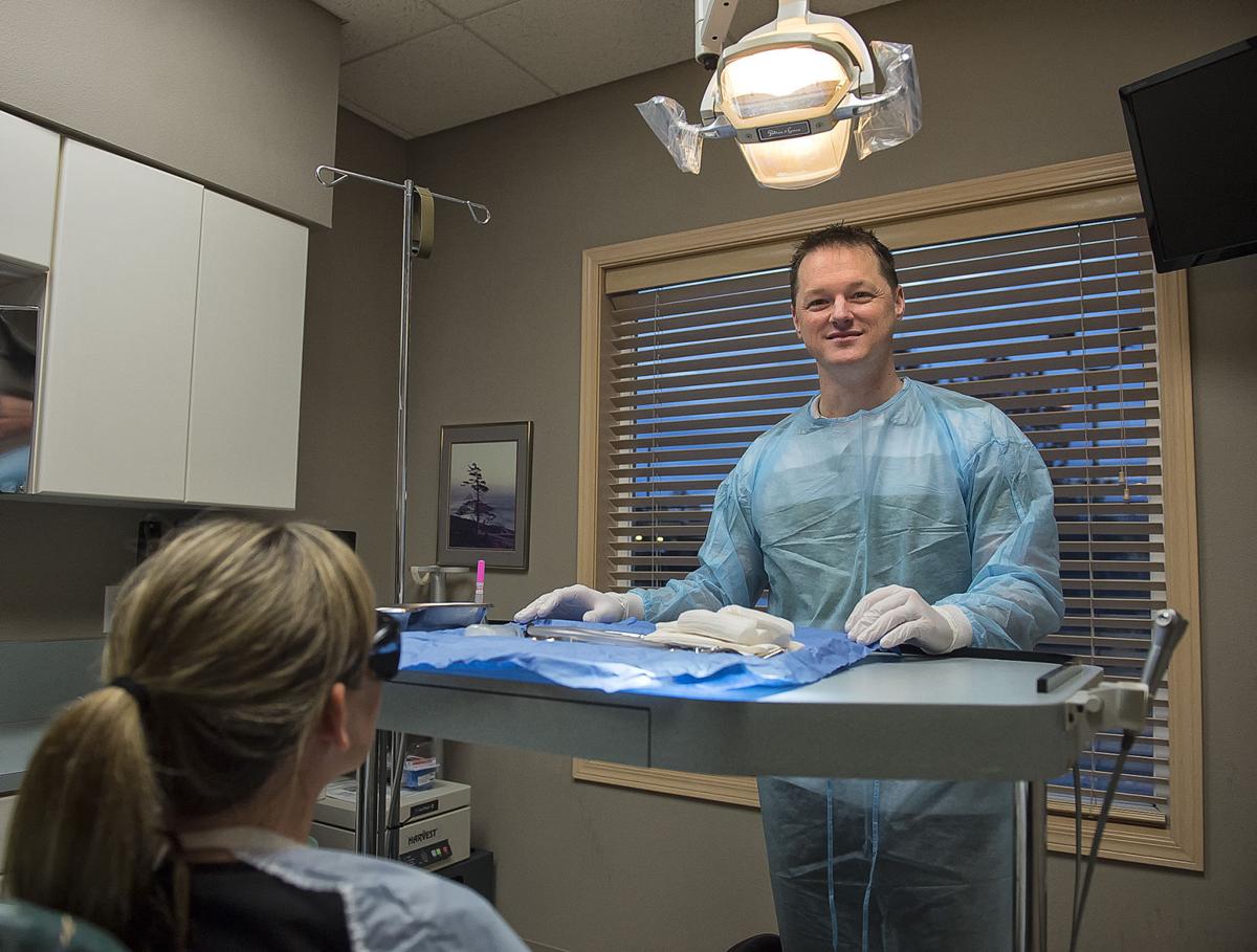Dr. Cabel McDonald Performing oral surgery with a smile