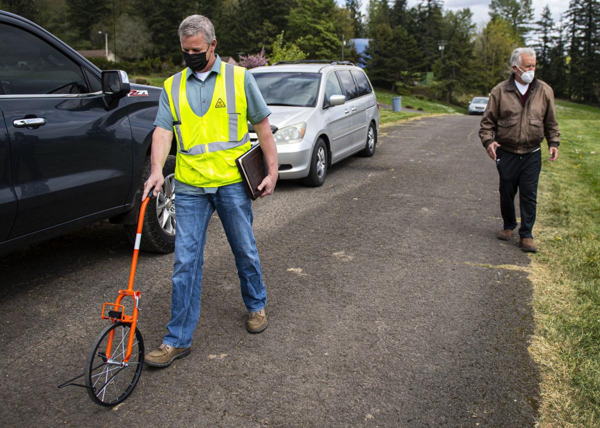 Retired Kelso barber, Lakeside Industries team up to fix deteriorating  Cowlitz View Memorial Gardens road