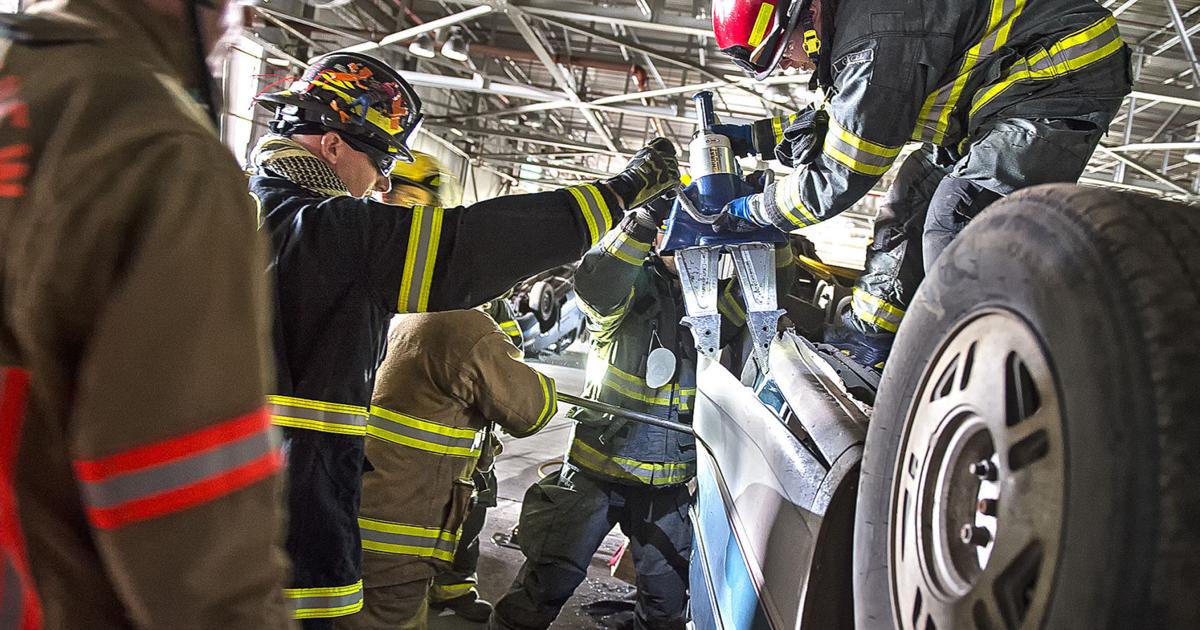 Firefighting Car Scissors Cutting Cars: Firefighters practice accident rescues