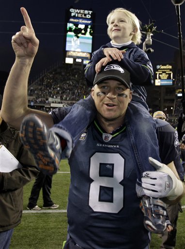 A stunned New Orleans Saints' Roman Harper walks off the field as the  Seattle Seahawks' celebrate their 41-36 win over the Super Bowl Defending  Champions in the NFC's wild-card playoff game on