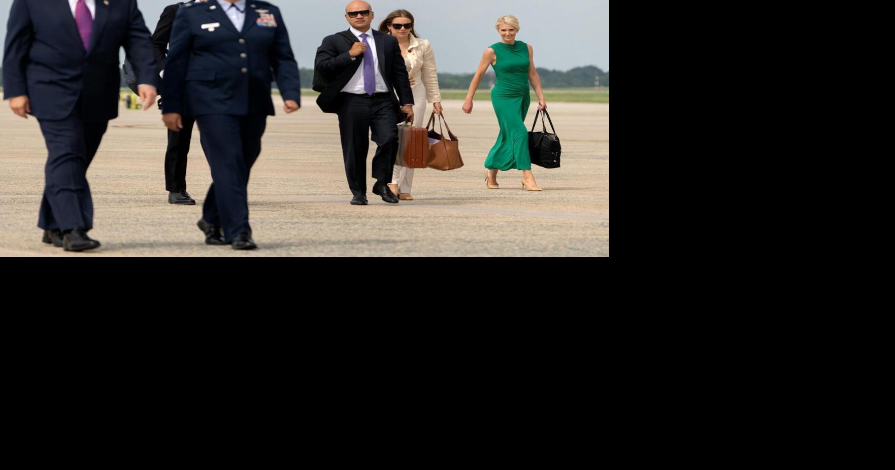 White House aide Natalie Harp, distant right, is often seen at President Donald Trump's side.