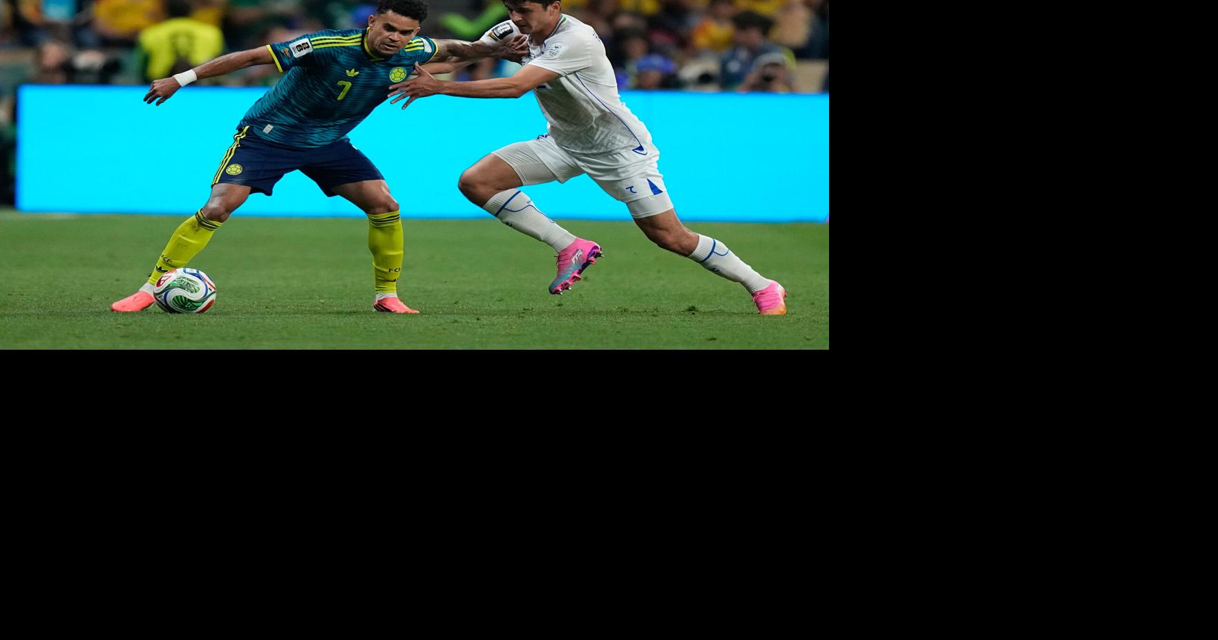 Uzbekistan's Abdukodir Khusanov collides with a camera operator in World Cup match vs. Colombia