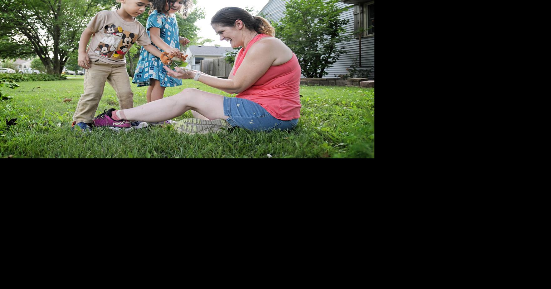 Wendy Mamola with her twin 4- year-olds Lennox and Wilhelmina in Rolling Meadows, Illinois, Friday, Aug. 7, 2026. They often spend time in the yard looking for treasures like bugs and flowers. Mamola has four children, all of whom have passed through the Head Start program.