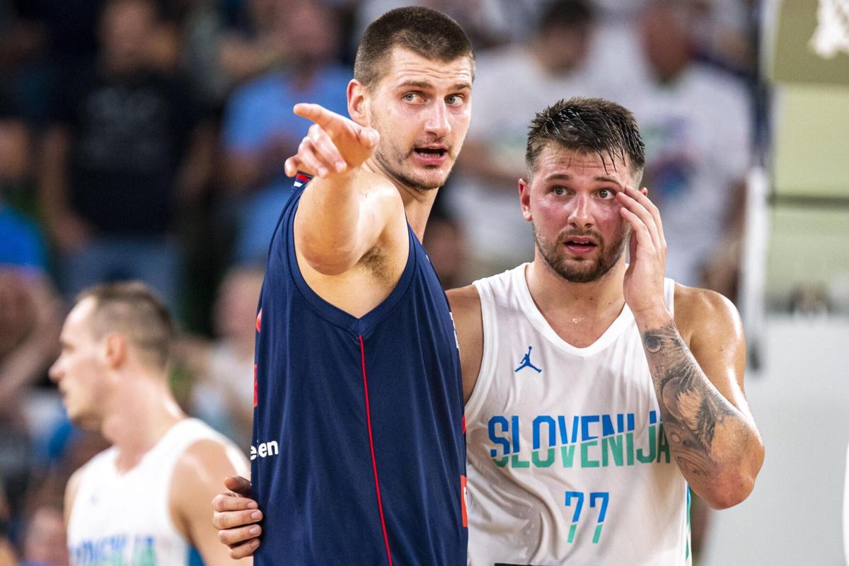 Luka Doncic of Slovenia and Nikola Jokic of Serbia react during