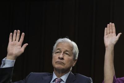 JPMorgan Chase& Co CEO Jamie Dimon raises his hand while responding to a question during a Senate Banking, Housing, and Urban Affairs Committee hearing on Capitol Hill Sept. 22, 2022, in Washington, D.C..