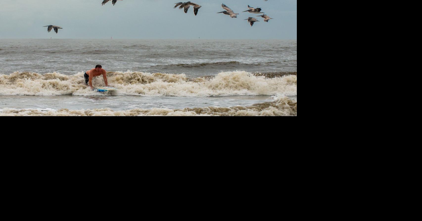 Surfers take advantage of high waves on St. Simons
