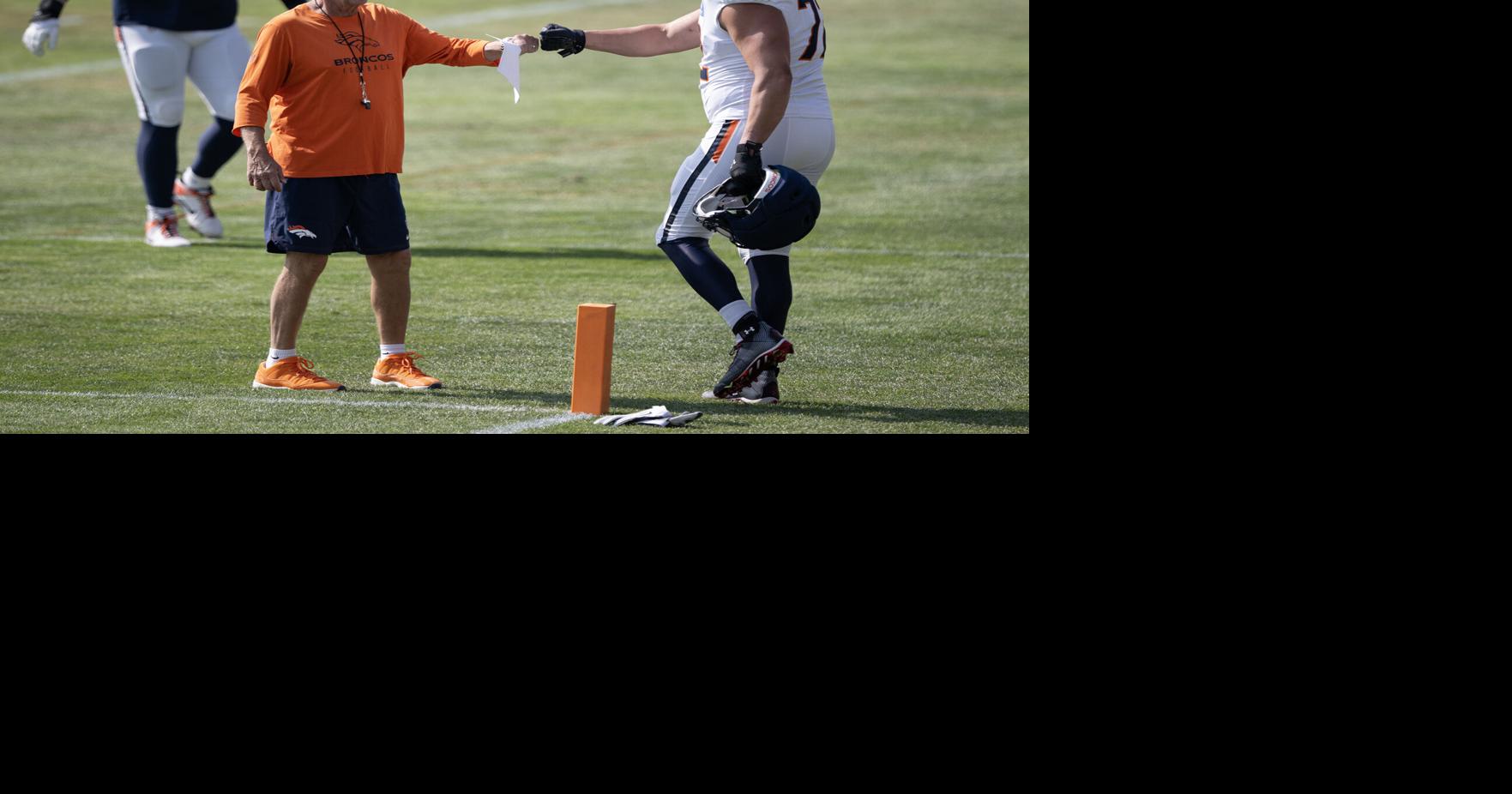 Head coach Sean Payton of the Denver Broncos fist bumps offensive tackle Garett Bolles during practice on Aug. 7, 2026, at Broncos Park in Centennial, Colorado.