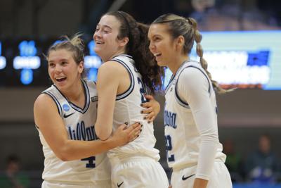 Villanova's Maddy Siegrist, middle, celebrates a basket with teammates Kaitlyn Orihel, left, and Bella Runyan.