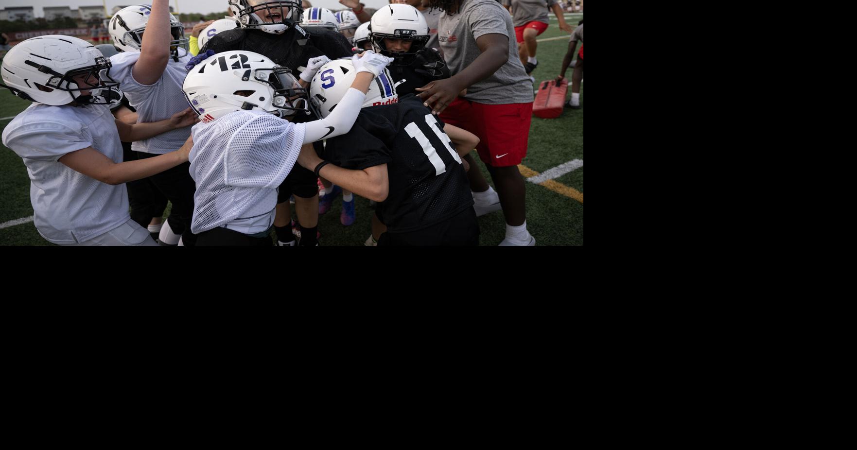 Players celebrate scoring in a team scrimmage during an Eaglecrest Youth Football Camp on Wednesday, June 24, 2026, at Legacy Stadium in Aurora, Colo..
