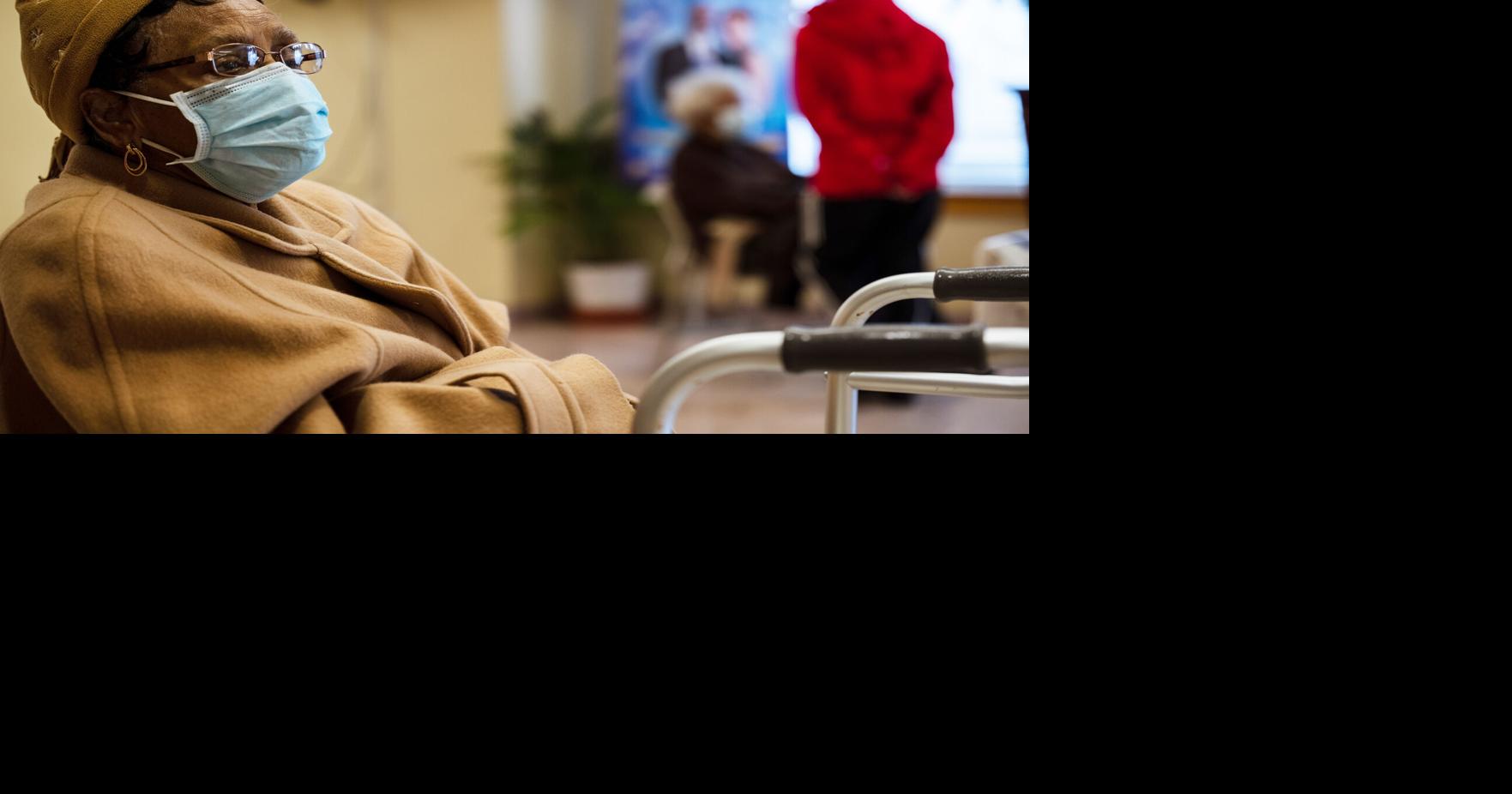 A woman who has just received her Moderna COVID-19 vaccine sits in the post-injection observation area in Bates Memorial Baptist Church Feb. 12, 2021, in Louisville, Kentucky.