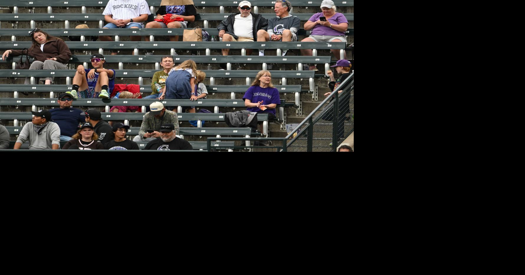 A pair of Colorado Rockies fans wear bags over their heads as they watch the Rockies play the Arizona Diamondbacks at Coors Field on Thursday, Sept. 24, 2026, in Denver.