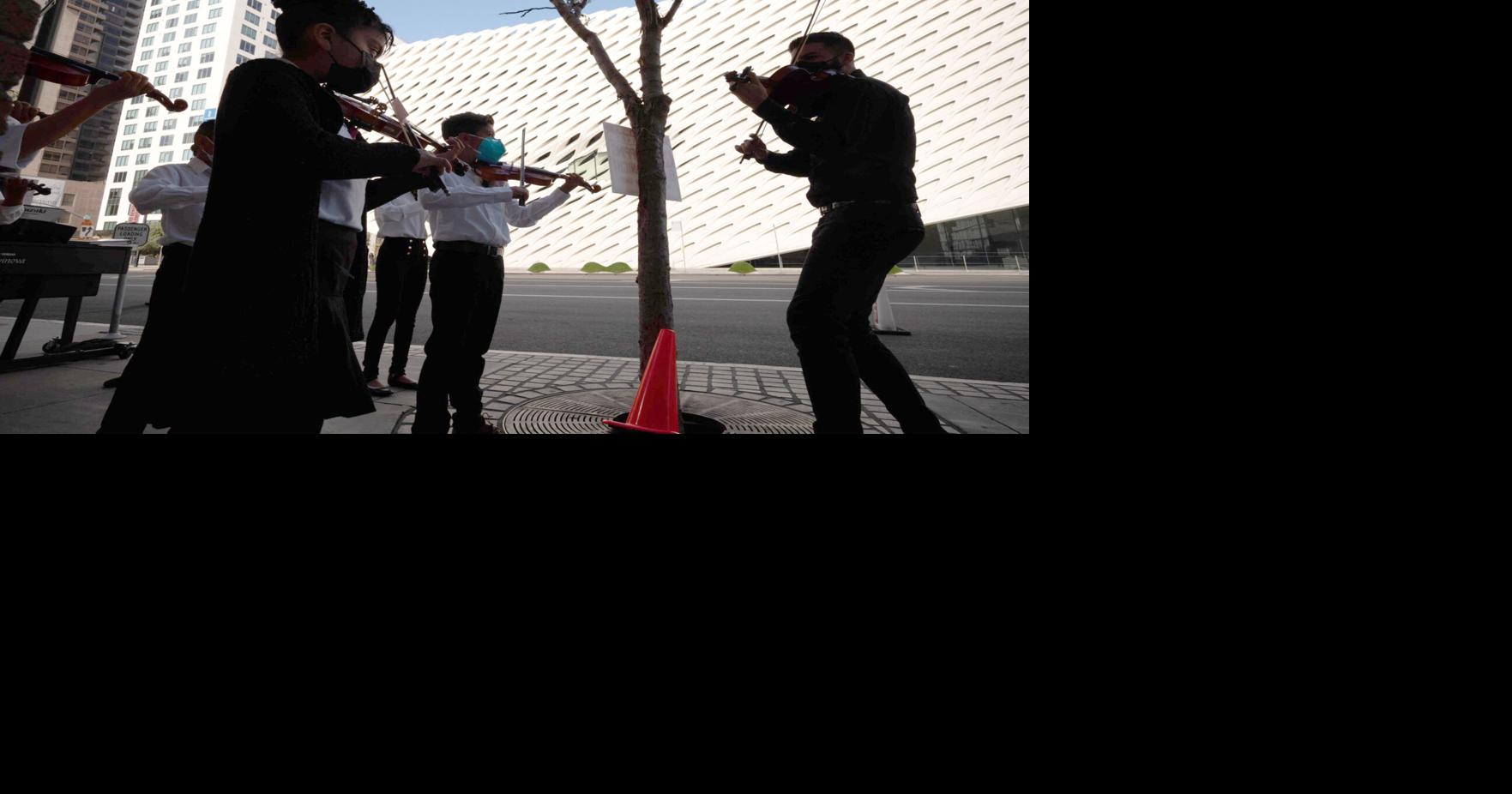 Students play outside of the Colburn School to welcome visitors to the unveiling of the new Frank Gehry- designed Colburn Center which will be added to the existing Colburn School in Los Angeles.