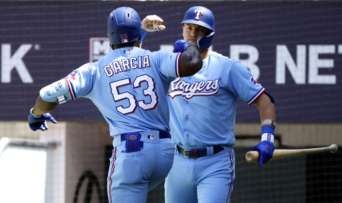 Adolis Garcia of the Texas Rangers celebrates with teammate Josh Jung after  hitting a solo home run against the New York Yankees during the fifth  inning at Globe Life Field on Apr.