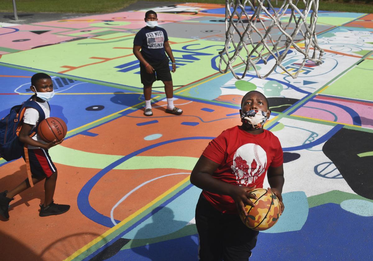 Basketball Donation Adds Even More Color To Mural Covered Court