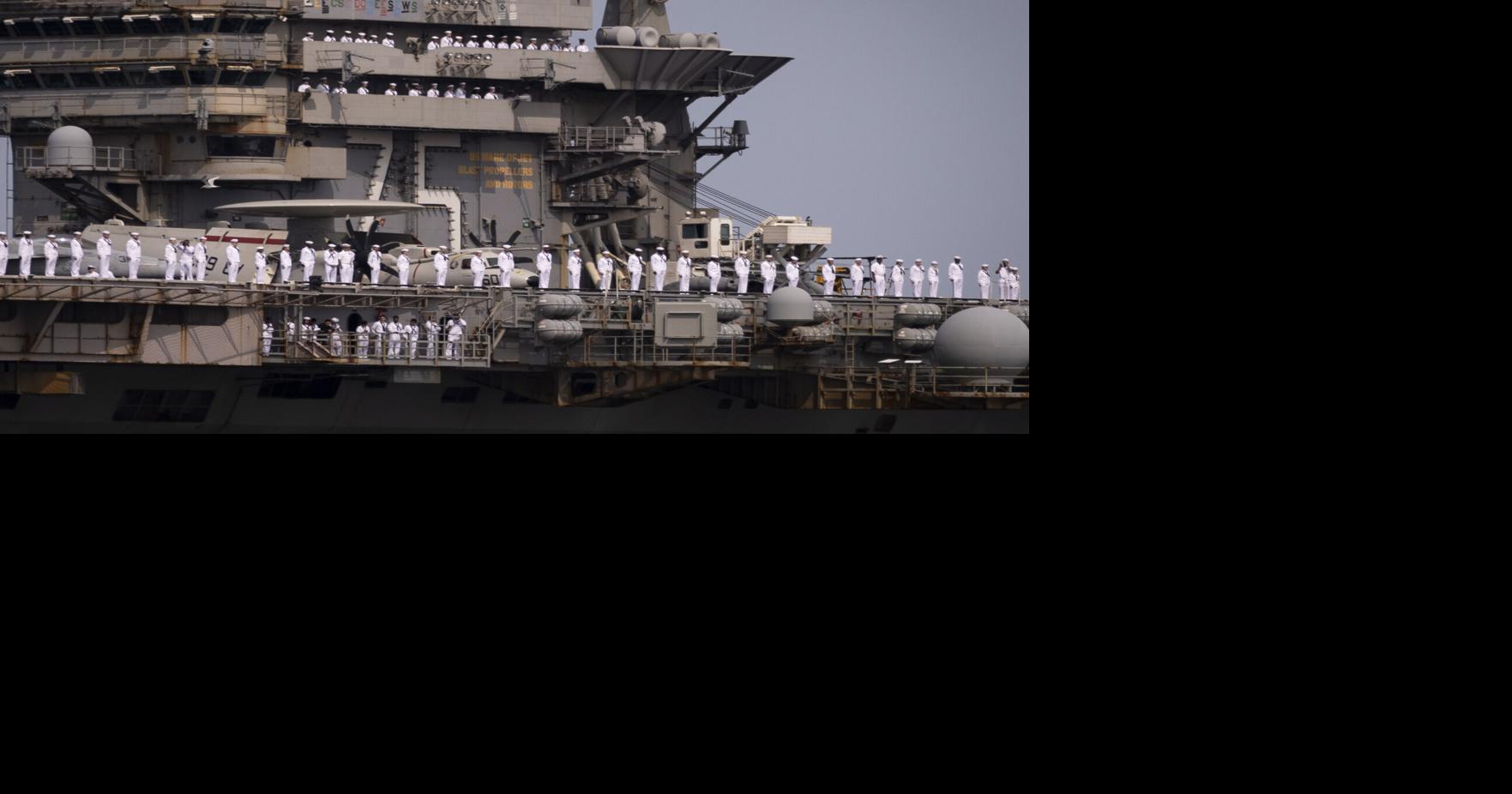 Sailors man the rails as the USS Harry S. Truman returns thousands of sailors from an eight-month deployment to Naval Station Norfolk in Norfolk, Virginia, on June 1, 2025.