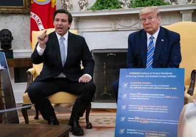 Ron DeSantis speaks while meeting with then U.S. President Donald Trump in the Oval Office of the White House in Washington, DC.