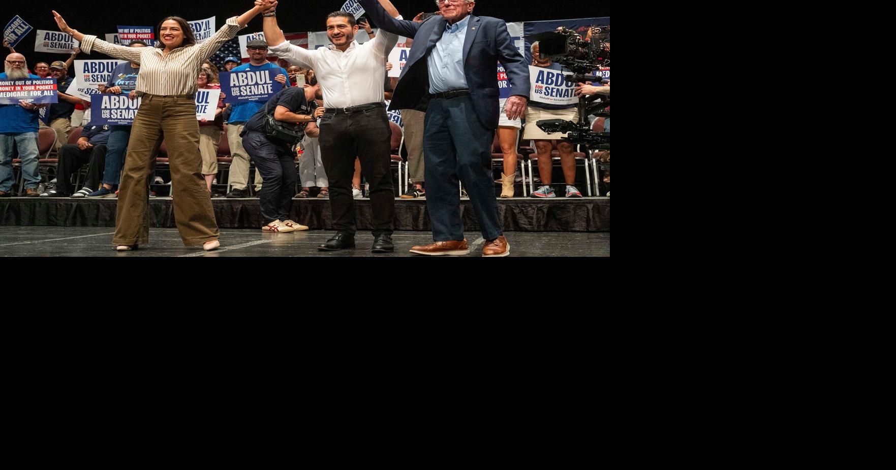 Bernie Sanders, right, join hands during a campaign rally for El-Sayed, a candidate for U.S. Senate in Michigan, on Saturday, July 18, 2026 at the Detroit Opera House in Detroit.