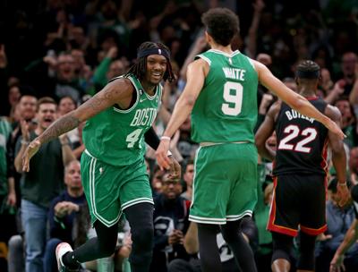 The Boston Celtics' Robert Williams III celebrates with teammate Derrick White as the Miami Heat's Jimmy Butler walks off in the second quarter during the Eastern Conference Finals at the TD Garden on May 25, 2023, in Boston.