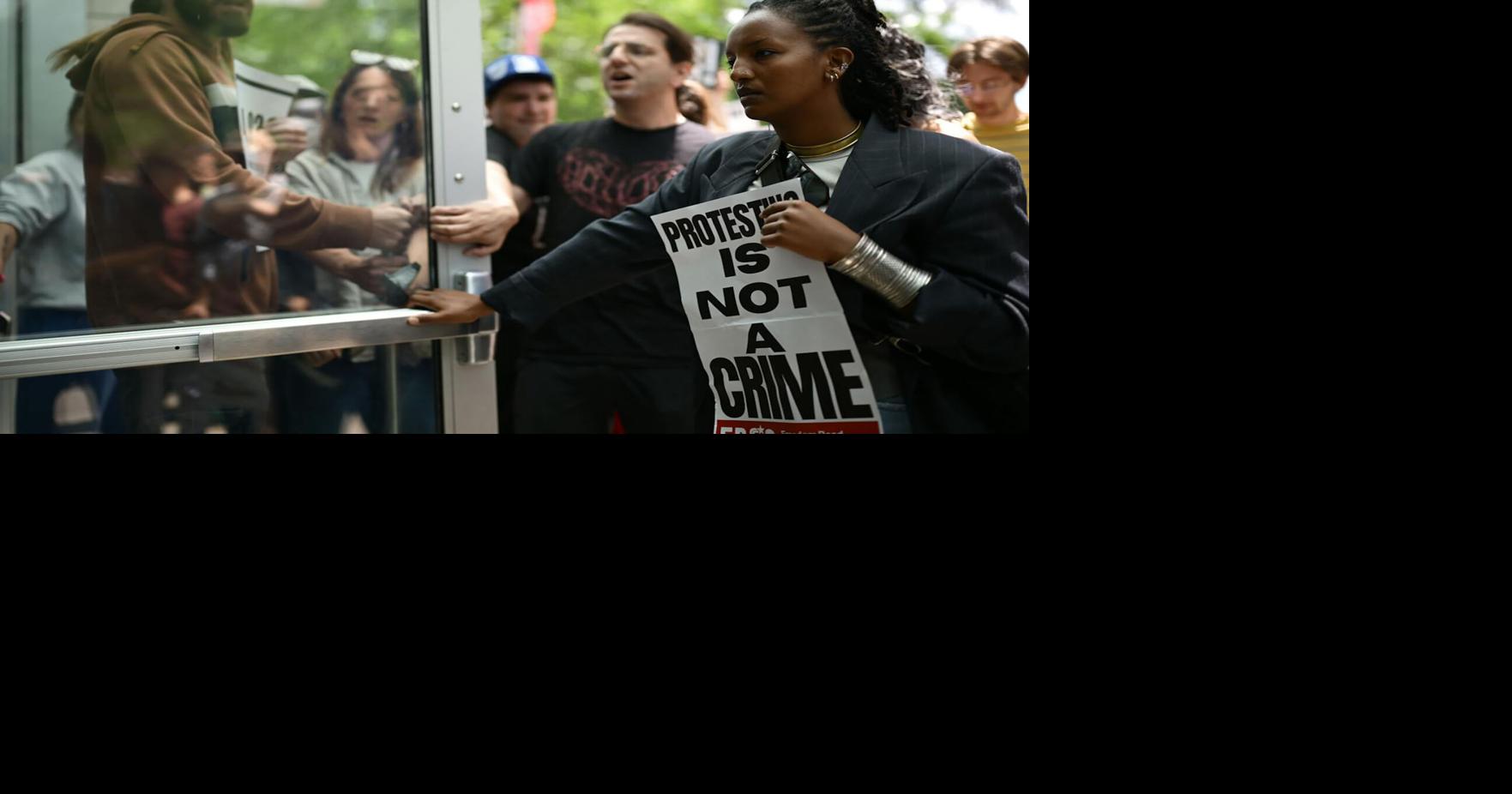 Protestors attempt to keep a door open to the St. Paul, Minnesota, federal courthouse in June 2026.