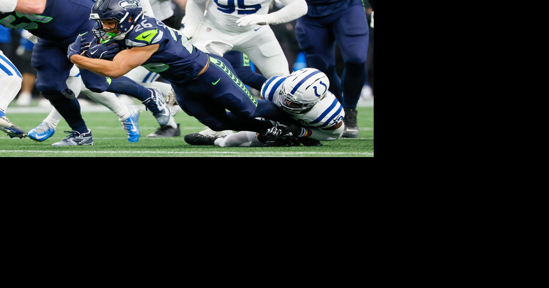 Seattle Seahawks running back Zach Charbonnet falls forward as he is tackled by Indianapolis Colts cornerback Kenny Moore II during the fourth quarter Sunday, Dec. 14, 2025, at Lumen Field in Seattle.