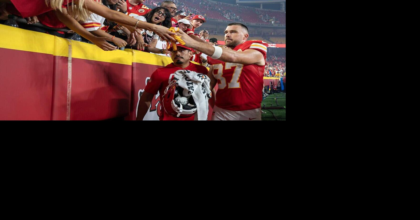 Kansas City Chiefs tight end Travis Kelce hands his glove to a fan while walking off the field after defeating the Indianapolis Colts 33-30 in overtime at Arrowhead Stadium on Sunday, Sept. 20, 2026, in Kansas City, Mo..