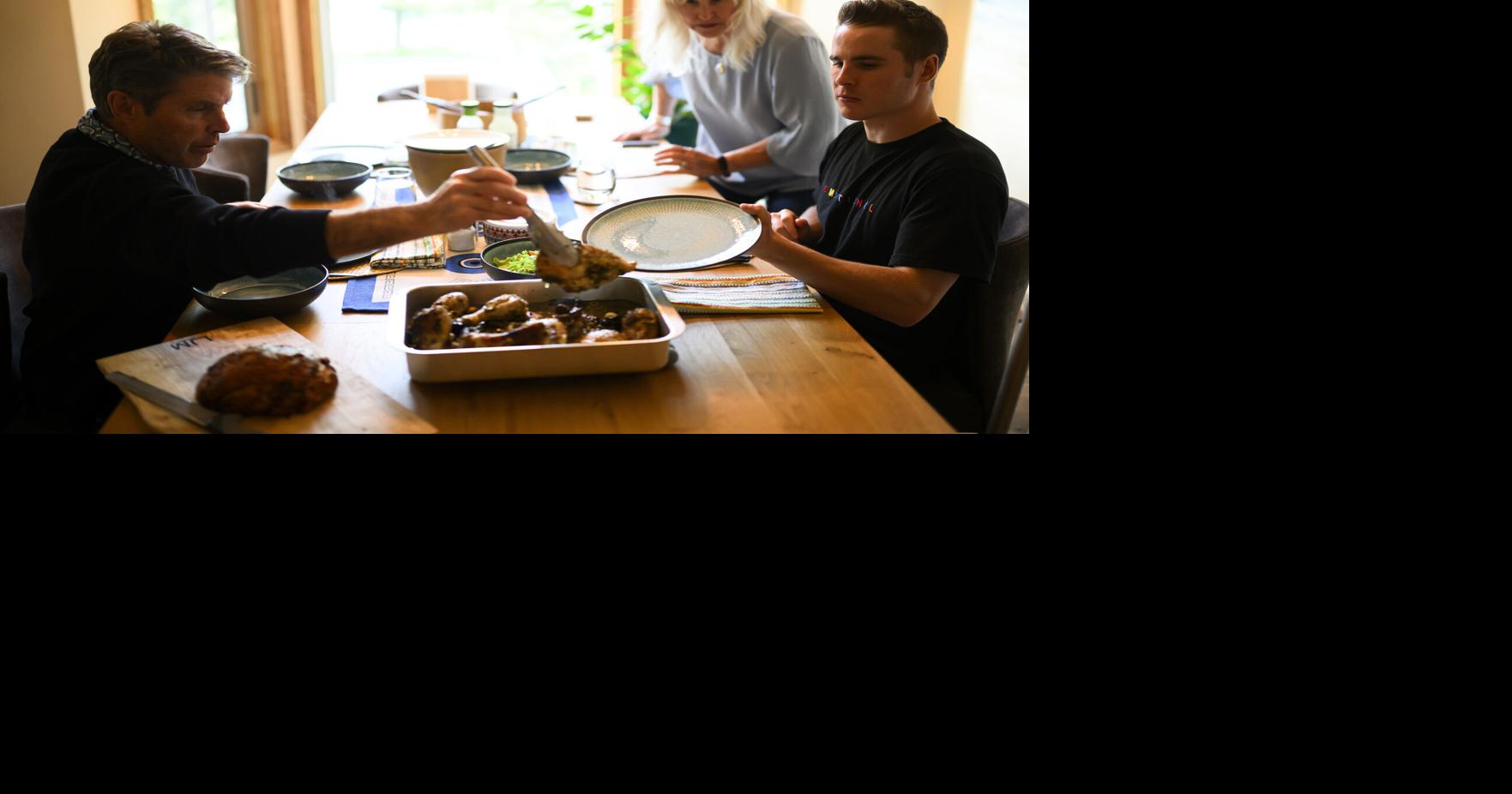 Mason Branstrator eats dinner with his parents Stacy Crawford and Donn Branstrator Tuesday, Aug. 18, 2026, in Duluth, Minn..