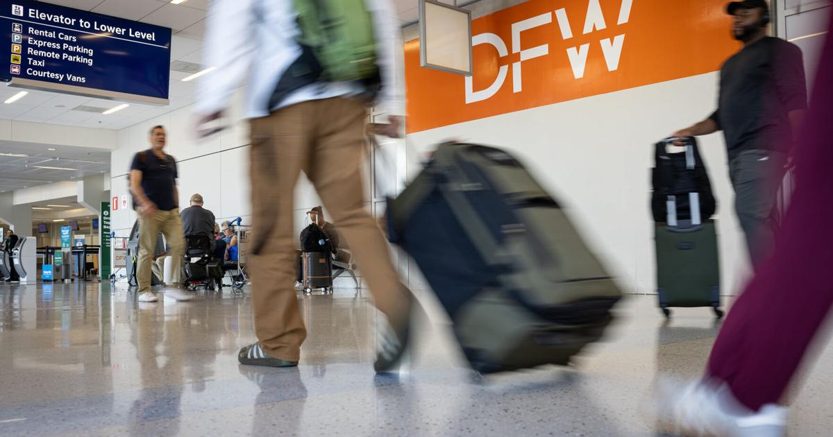 Airline travelers exit baggage claim in Terminal E at Dallas Fort Worth International Airport on Sept. 11, 2025.