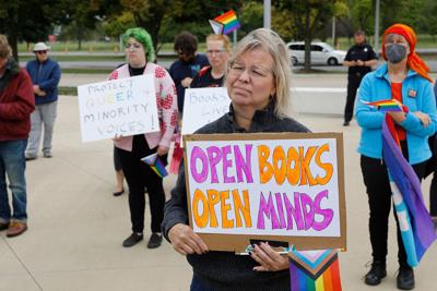 Demonstrators gather to protest against banning books outside of the Henry Ford Centennial Library in Dearborn, Michigan, on Sept. 25, 2022.