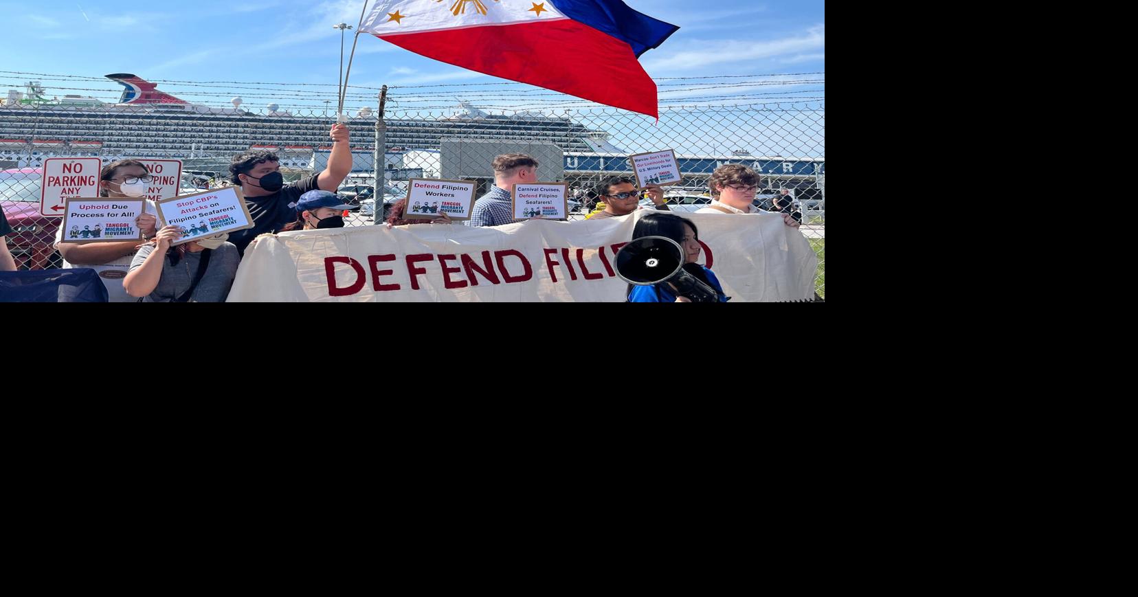 A Philippines flag is flown against the backdrop of a Carnival Cruise ship that four Filipino seafarers were allegedly arrested and deported from last week.
