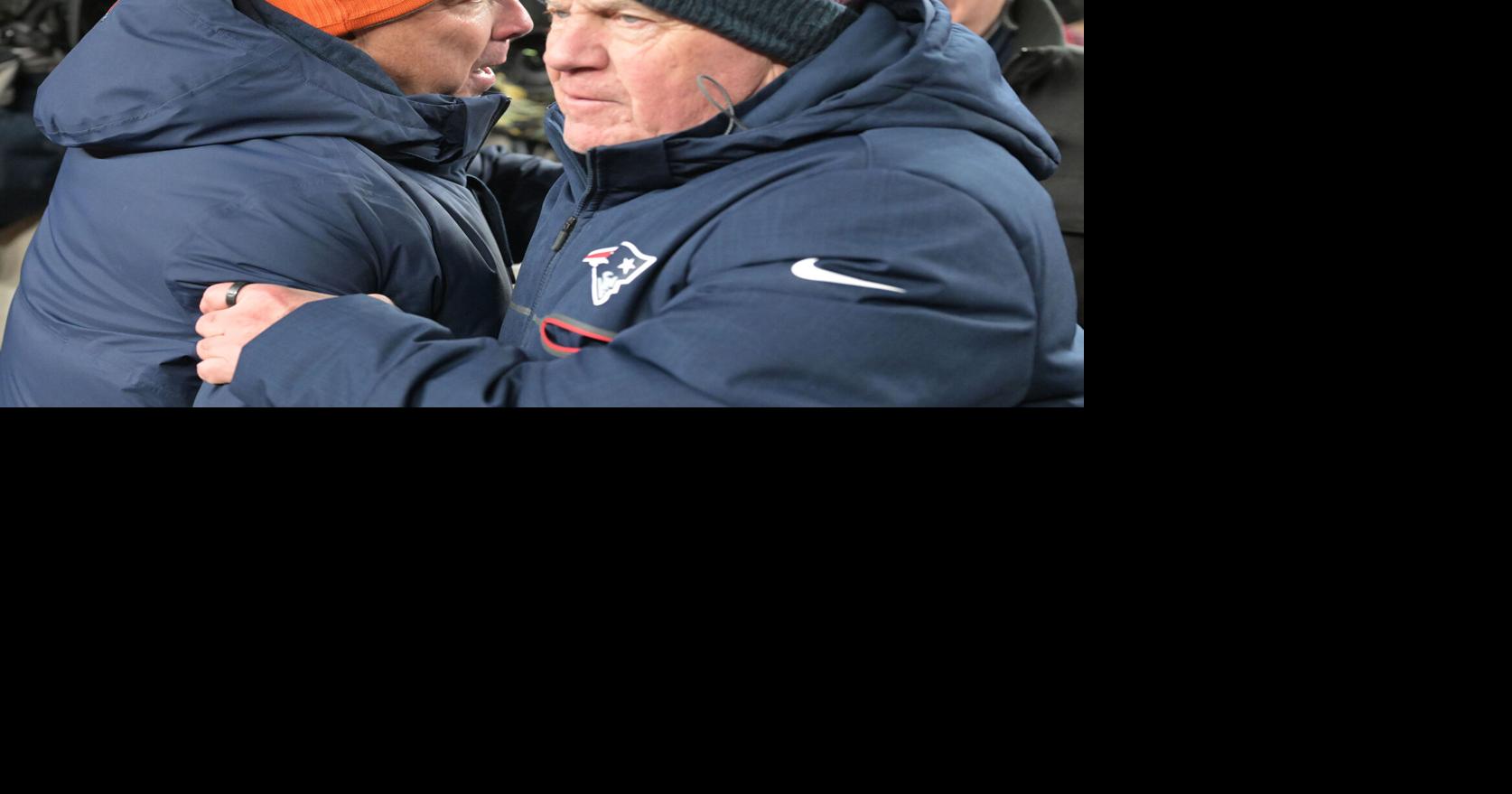 Denver Broncos head coach Sean Payton, left, meets with New England Patriots head coach Bill Belichick at midfield after the game at Empower Field at Mile High in Denver on Dec. 24, 2023.