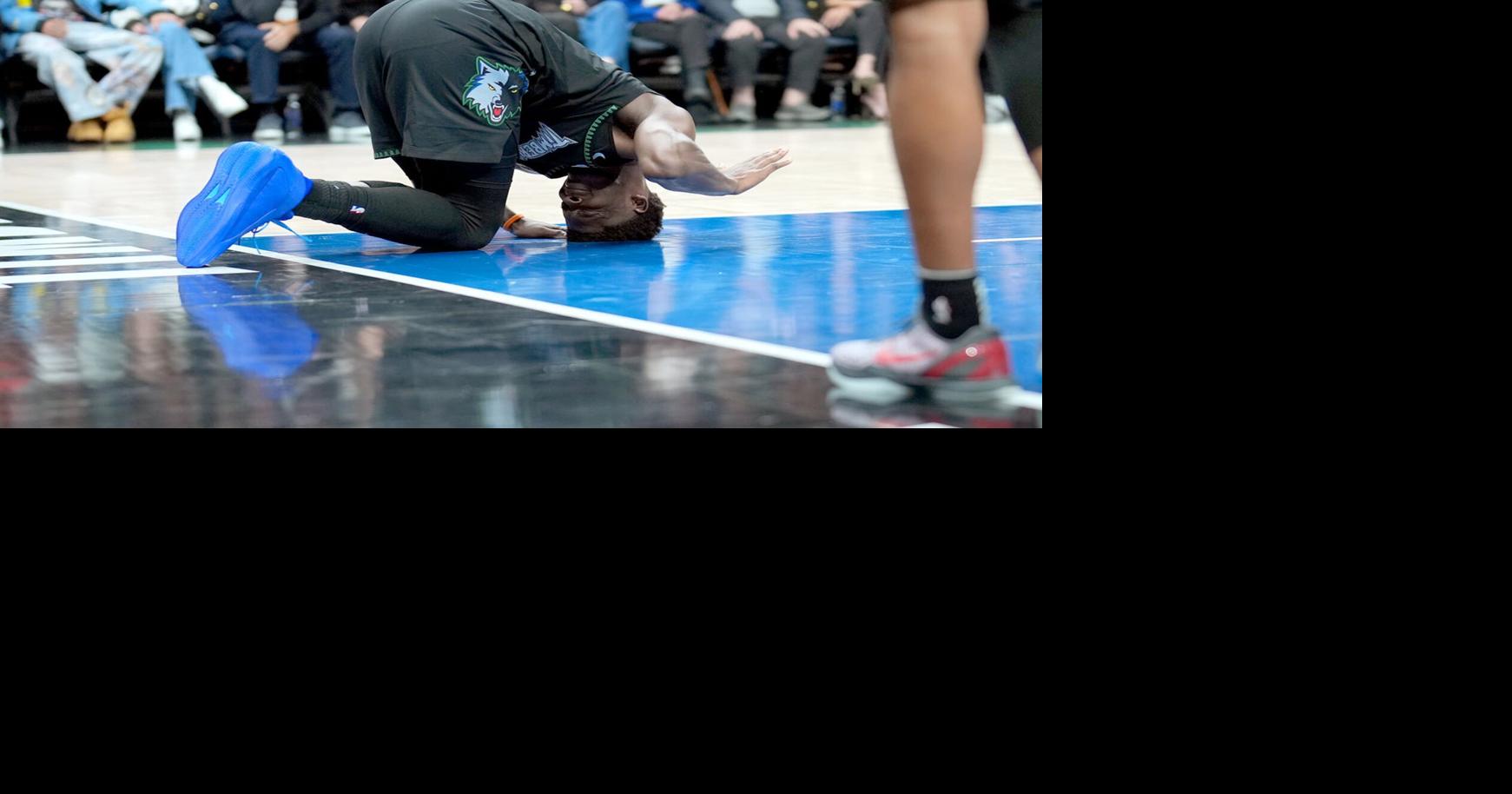 The Minnesota Timberwolves' Anthony Edwards reacts after he suffered a left knee injury during the second quarter in Game 4 against the Denver Nuggets on April 25, 2026, at Target Center in Minneapolis.