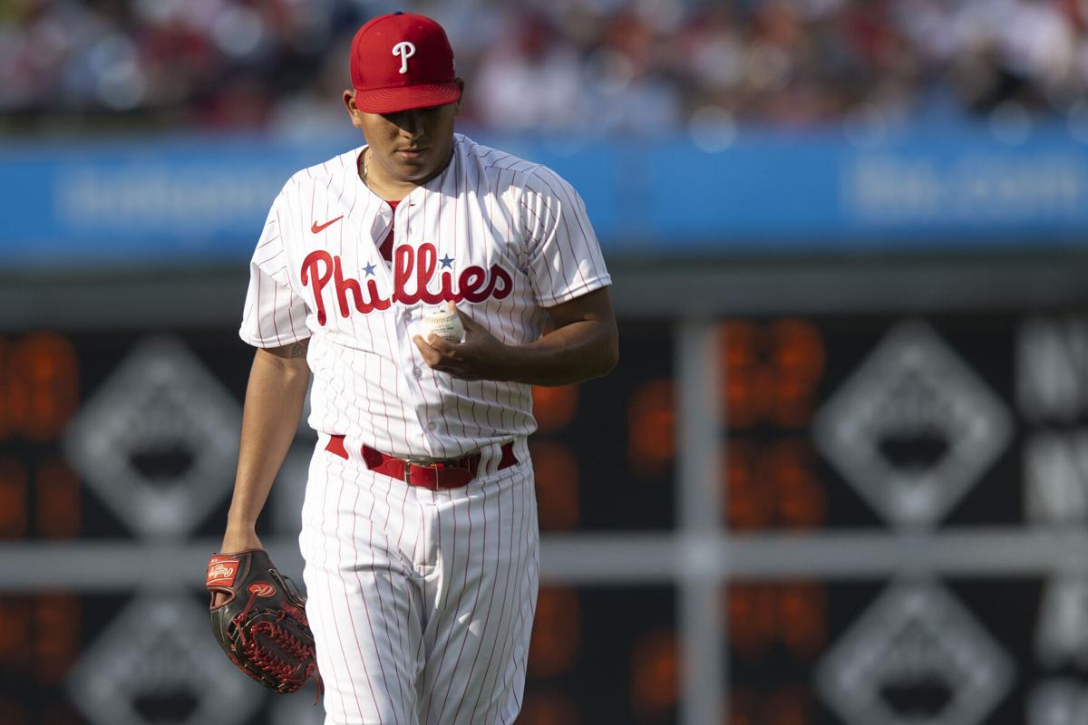 Philadelphia Phillies starting pitcher Ranger Suarez, left, walks