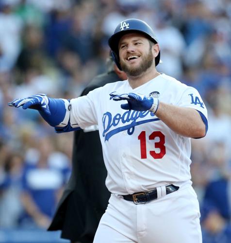 The Los Angeles Dodgers' Max Muncy crosses home plate after hitting a  two-run home run