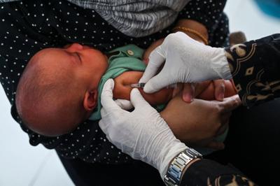 A baby receives the Bacillus Calmette-Guerin vaccine for tuberculosis during a national immunization for children program at an integrated services post in Banda Aceh, Indonesia, on June 9, 2022.