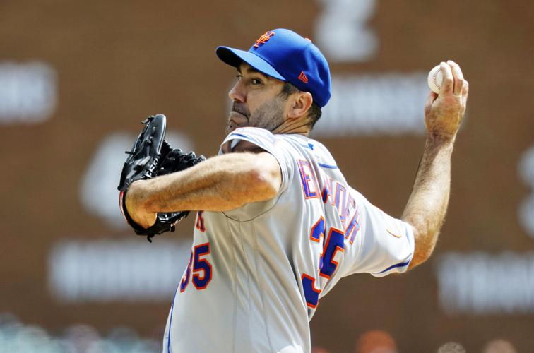 New York Mets starting pitcher Pedro Martinez puts his glove to
