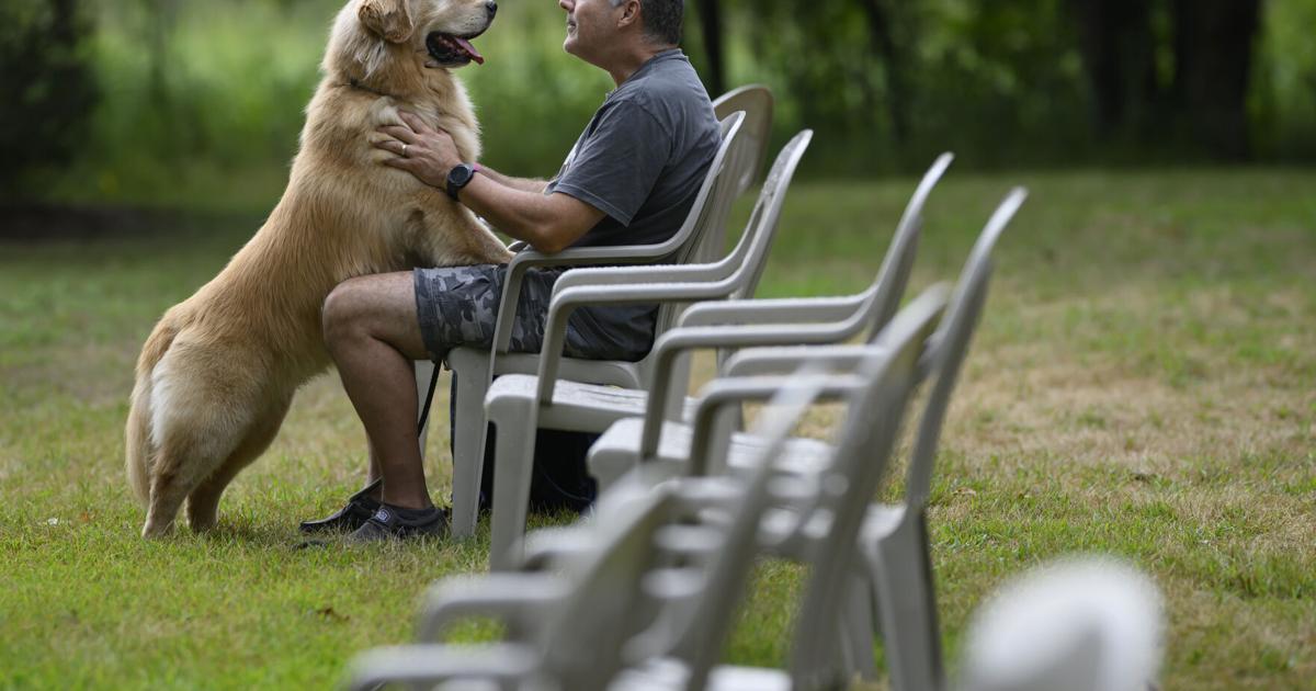 Pat McCarver, of Blaine, Minnesota, shares a moment with his 7- year old Golden Retriever, CJ, on Aug. 7, 2026, at Game Fair in Ramsey, Minnesota.