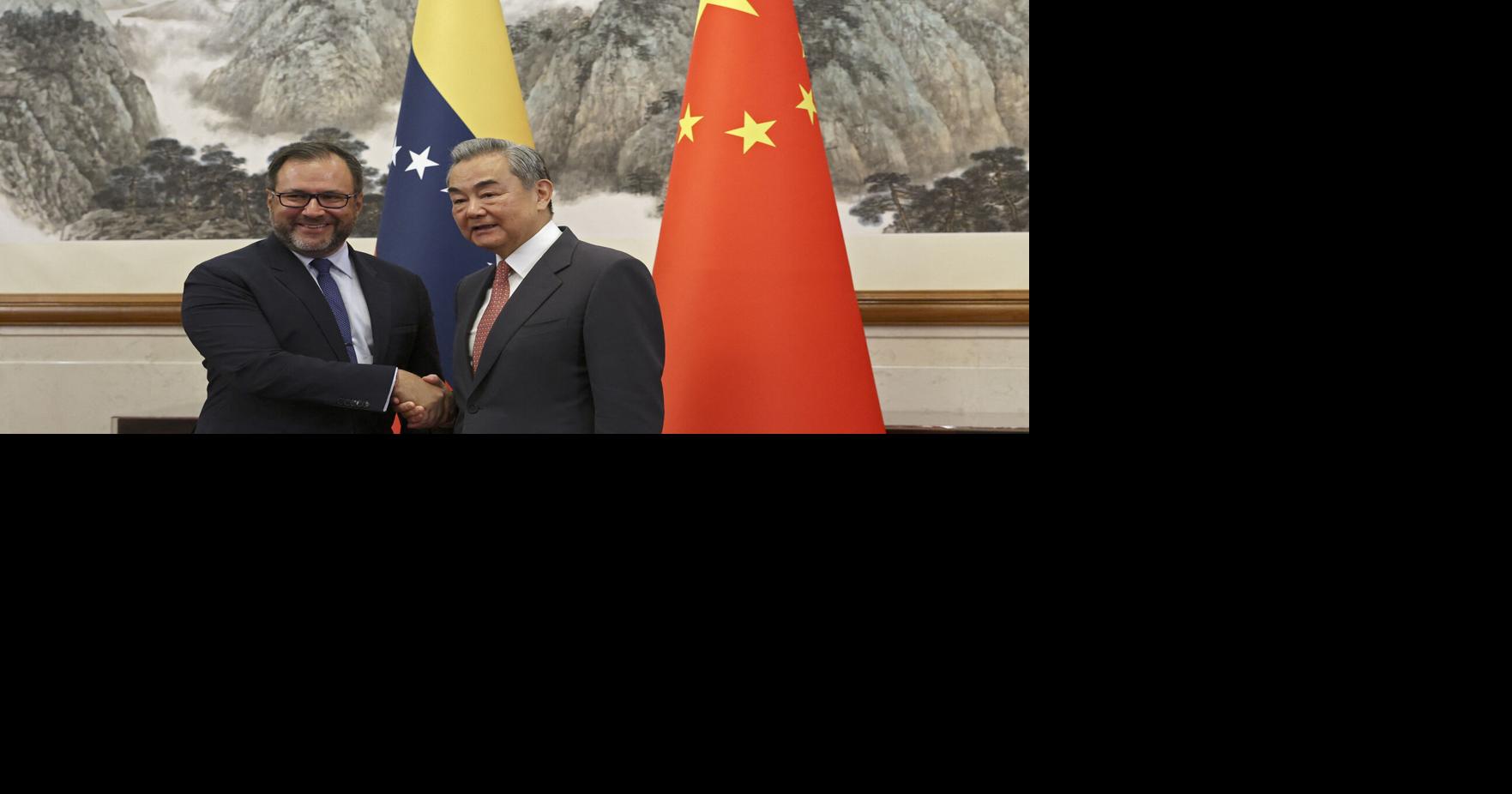 Chinese Foreign Minister Wang Yi, right, and Venezuela's Foreign Minister Yvan Gil shake hands before their meeting at the Diaoyutai State Guesthouse in Beijing on May 12, 2025.