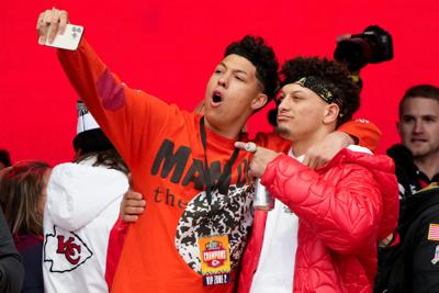 Jackson Mahomes, left, and his brother, Kansas City Chiefs quarterback Patrick Mahomes celebrate on stage during the team's Super Bowl LVII victory parade on Feb. 15, 2023, in Kansas City, Missouri.