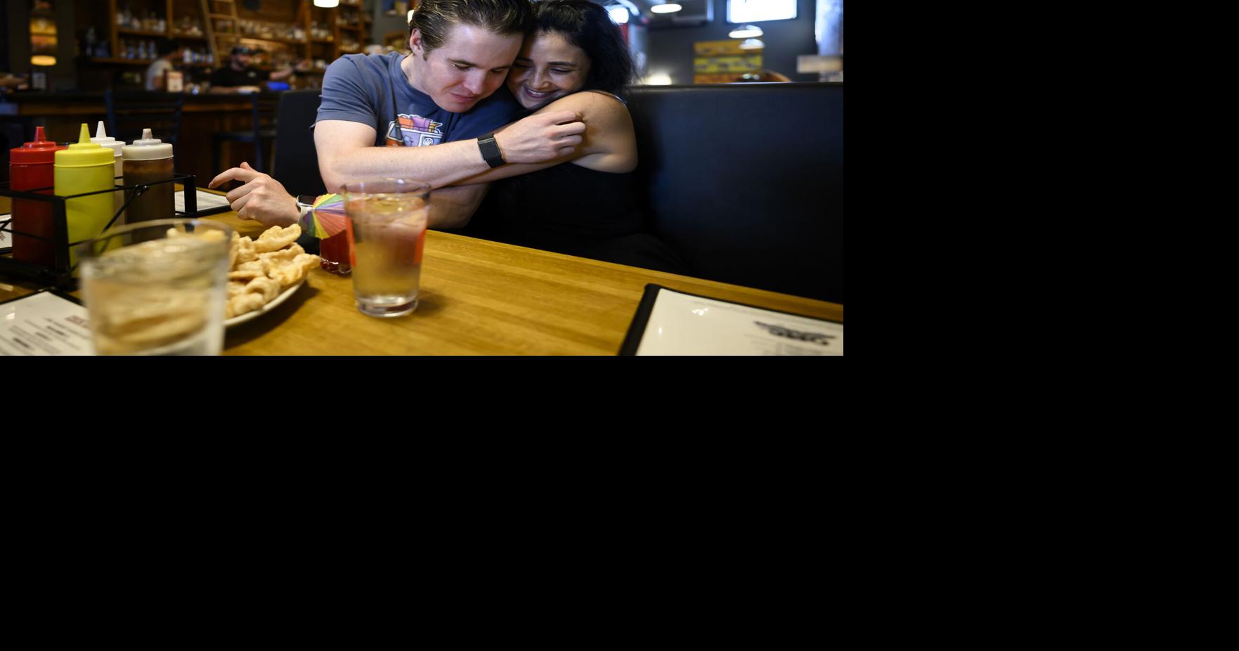 Mason Branstrator embraces his girlfriend, Victoria Duenes, as he arrives at OMC Smokehouse for dinner before a sailing outing Tuesday, July 28, 2026, in Duluth, Minn..