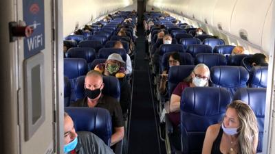 Masked passengers fill a Southwest Airlines flight from Burbank to Las Vegas on June 3, 2020, with middle seats left open.