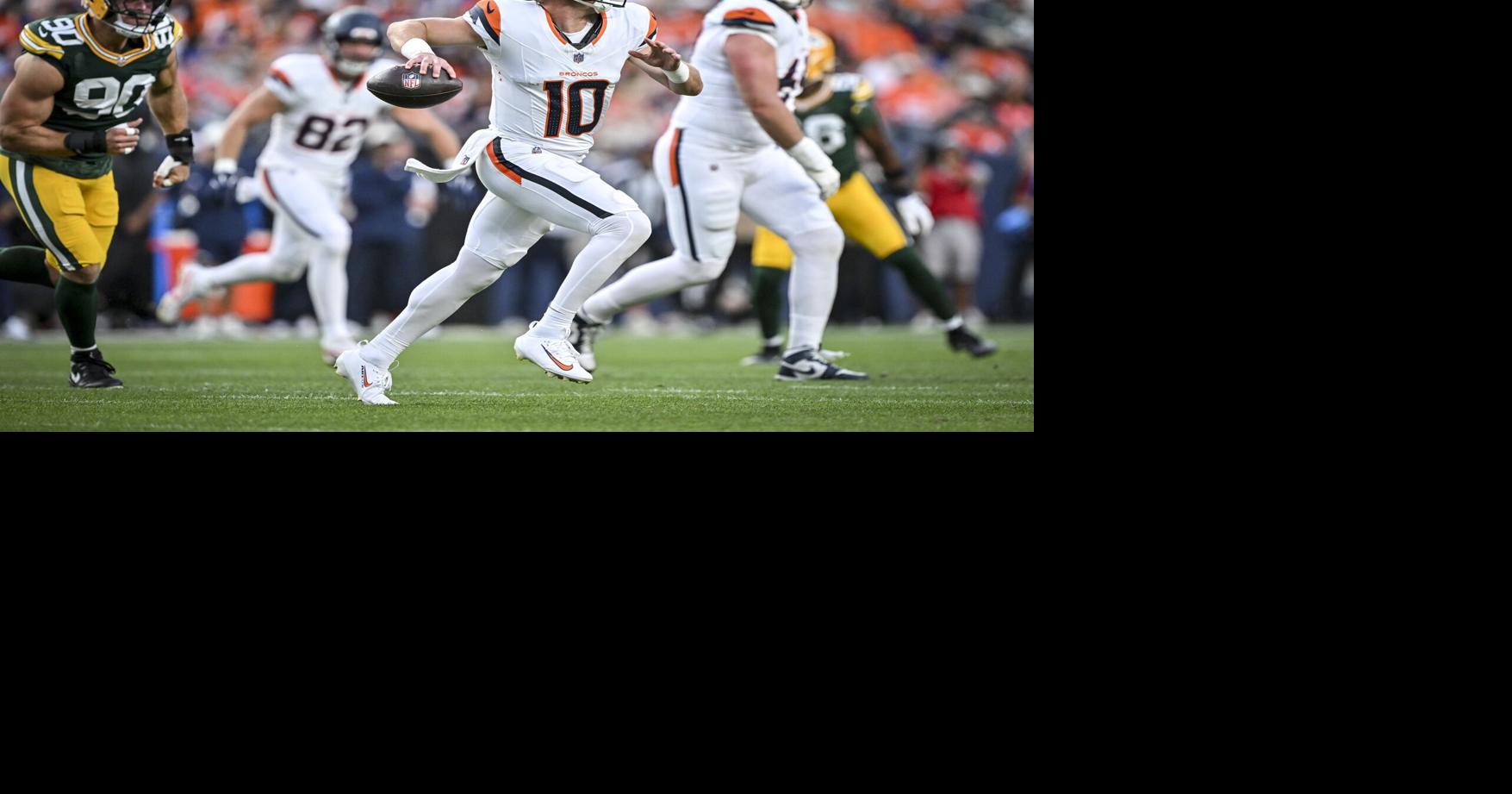 Denver Broncos quarterback Bo Nix rolls out to throw as the Green Bay Packers' Lukas van Ness pressures in the first quarter during a preseason game at Empower Field at Mile High in Denver on Aug. 21, 2026.