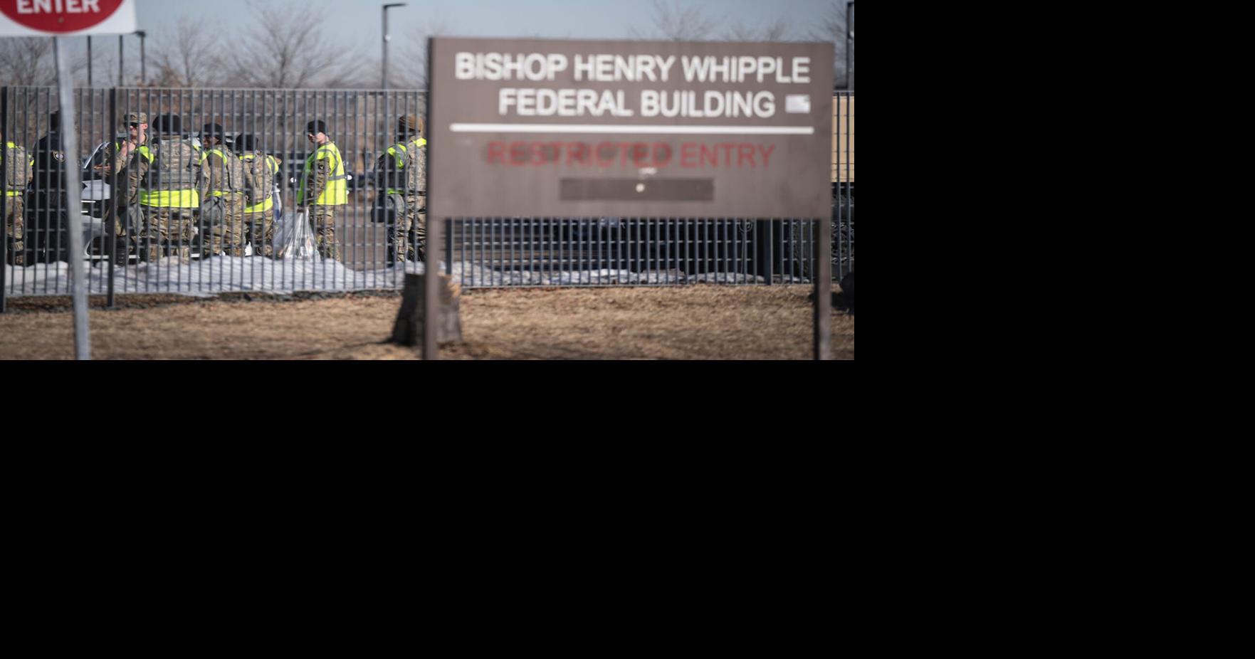 Several National Guard men and women mingle outside the Bishop Henry Whipple Federal Building in Fort Snelling, Minnesota, on Feb. 13, 2026.