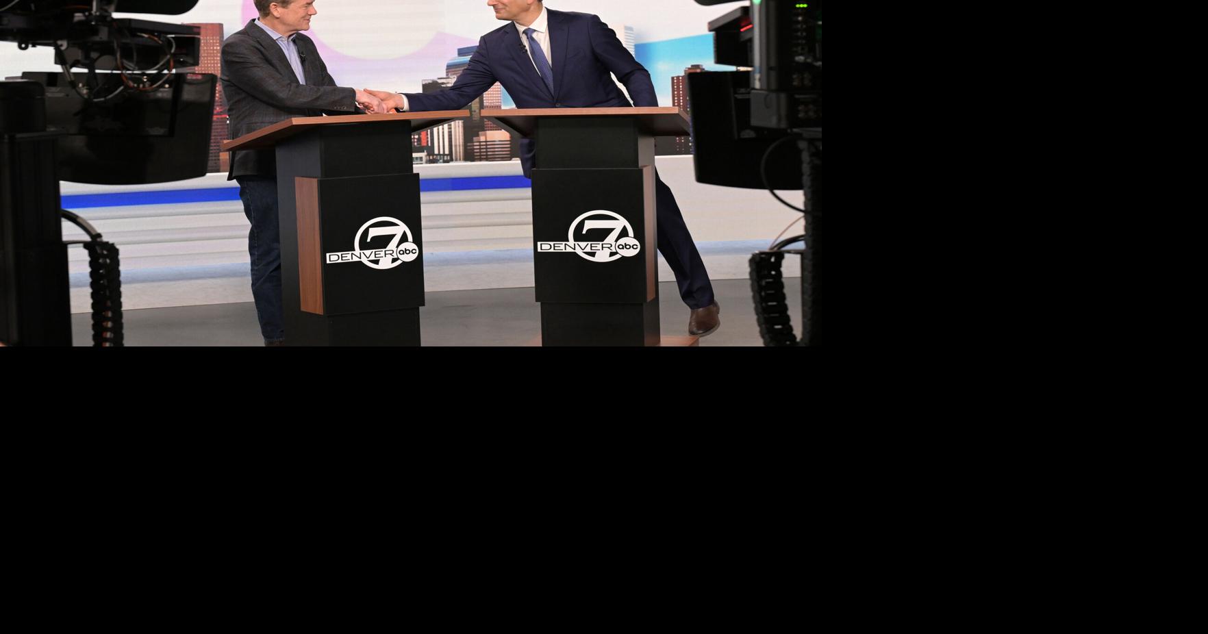 Michael Bennet, left, and Attorney General Phil Weiser, both running for the Democratic nomination for governor of Colorado, shake hands after a debate at the Denver7 studios on May 7, 2026, in Denver.